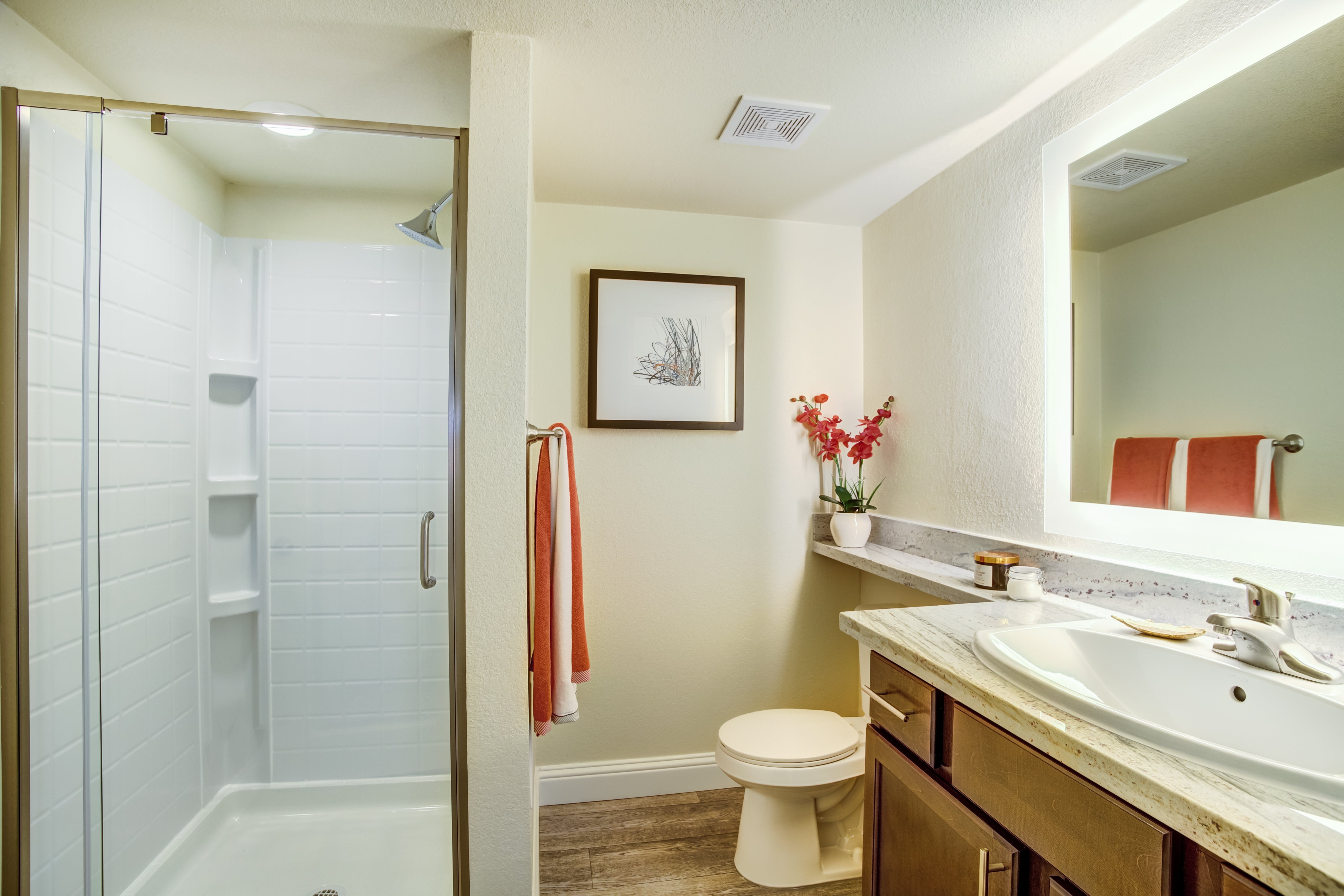 A bathroom with a toilet, sink, and shower.